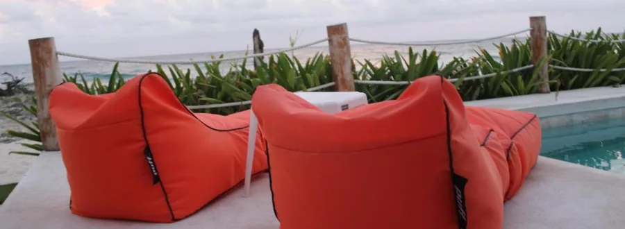 Bean bags by the pool at dusk at Punta Piedra Studios
