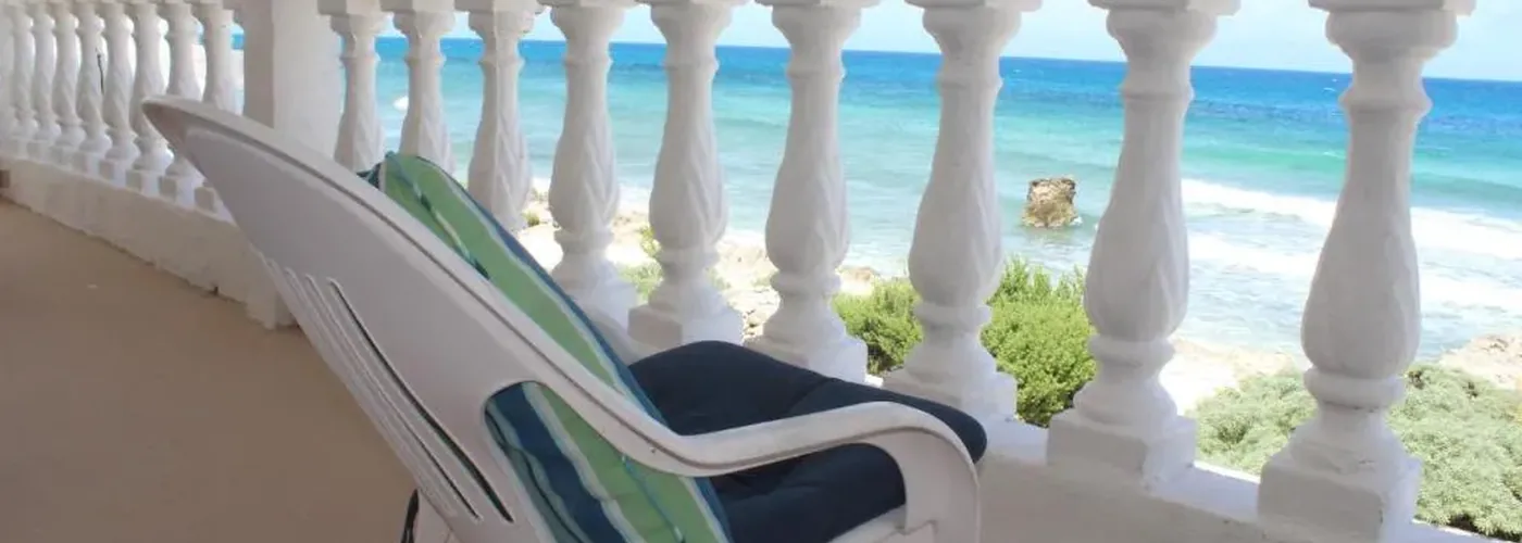 Balustraded terrace of the Beachfront Villa over turquoise water